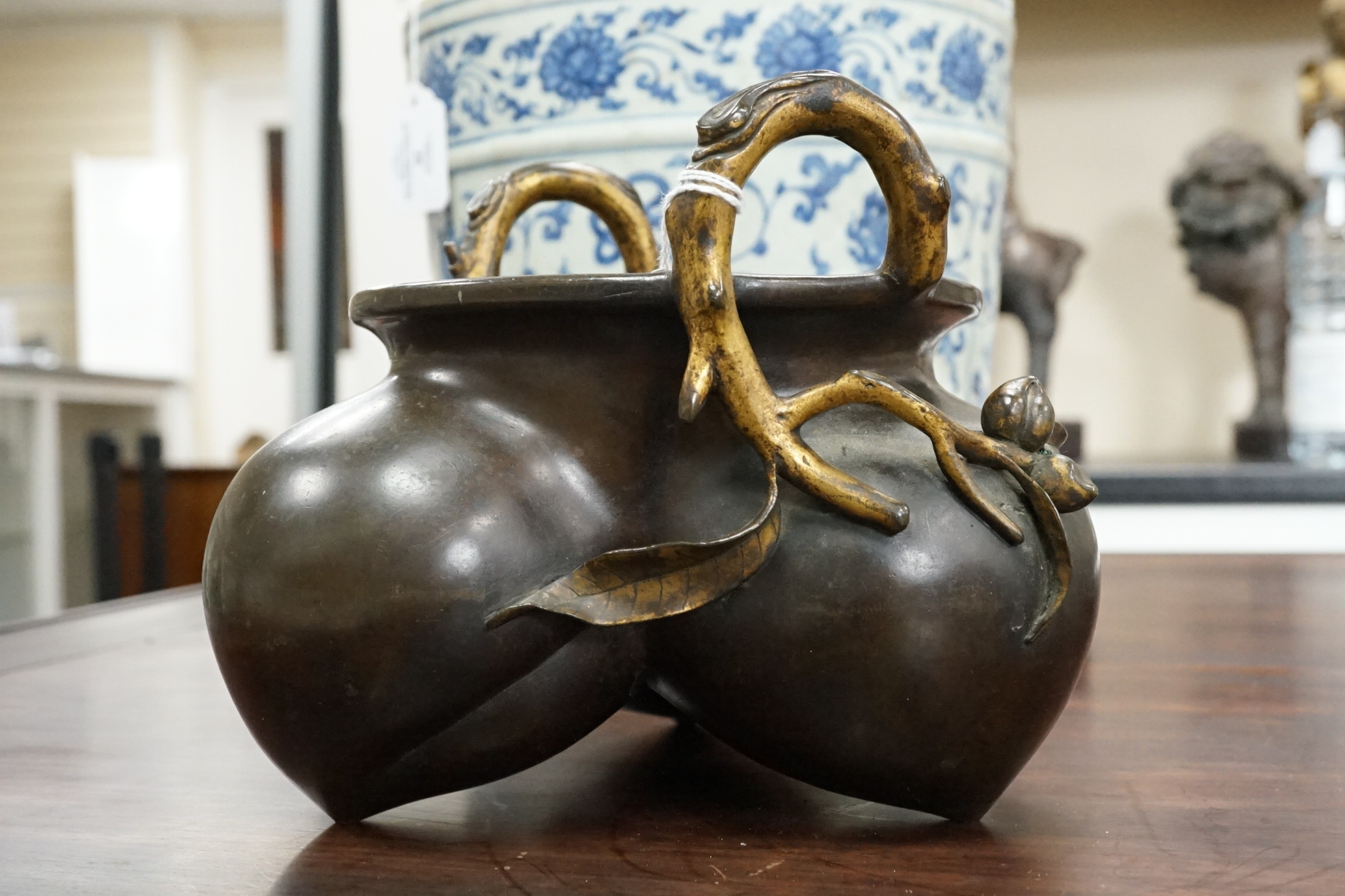 A large Chinese bronze and parcel gilt ‘peach’ censer and cover, Li, 17th/18th century